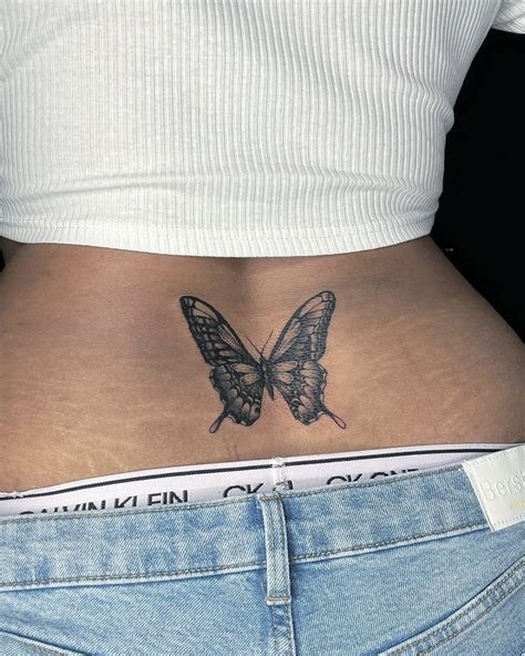 Butterfly lower back tattoo